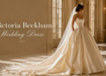 Luxury champagne bridal ball gown inspired by Victoria Beckham wedding dress style in a grand castle hall
