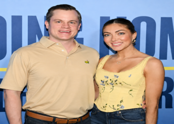 Jett Puckett and his wife Campbell posing together at an outdoor event.